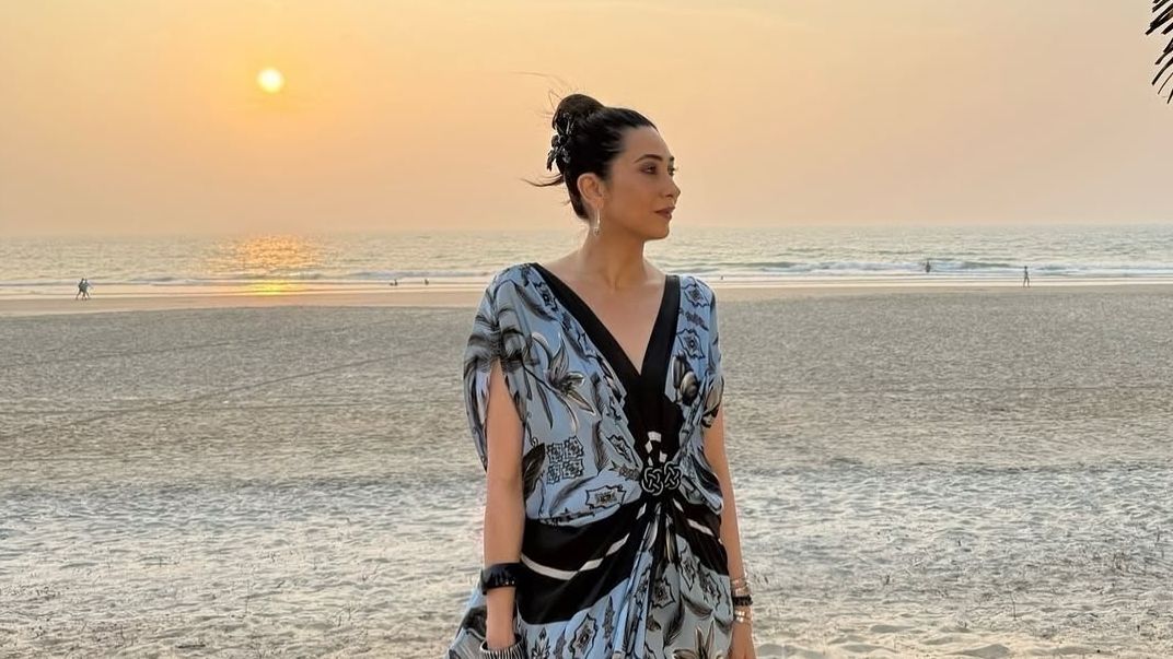 Karisma Kapoor serves bohemian beachwear inspiration in a printed hand-draped kaftan dress