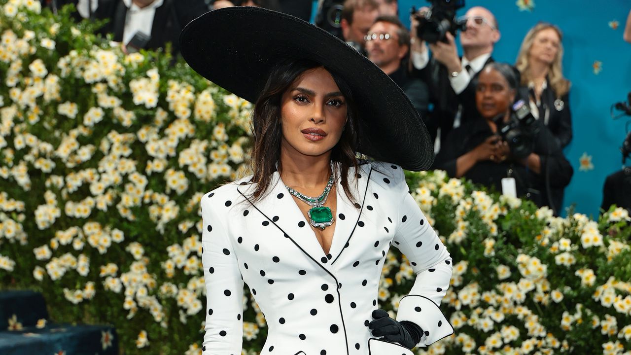 Priyanka Chopra paired her Balmain polka dot jacket and dress with a 241-carat emerald necklace at the Met Gala