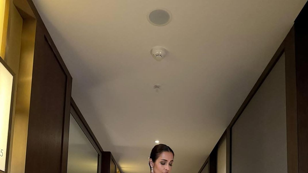 Malaika Arora is in a champagne Tarun Tahiliani concept sari that is elevated with Swarovski crystals
