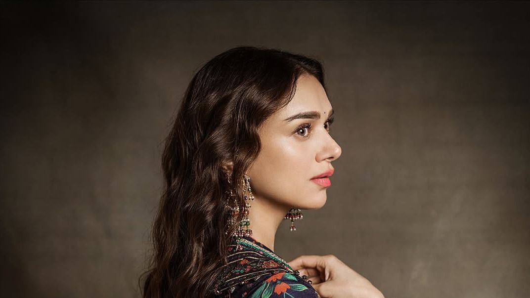 Aditi Rao Hydari’s floral anarkali layers vivid panels under a sheer navy drape