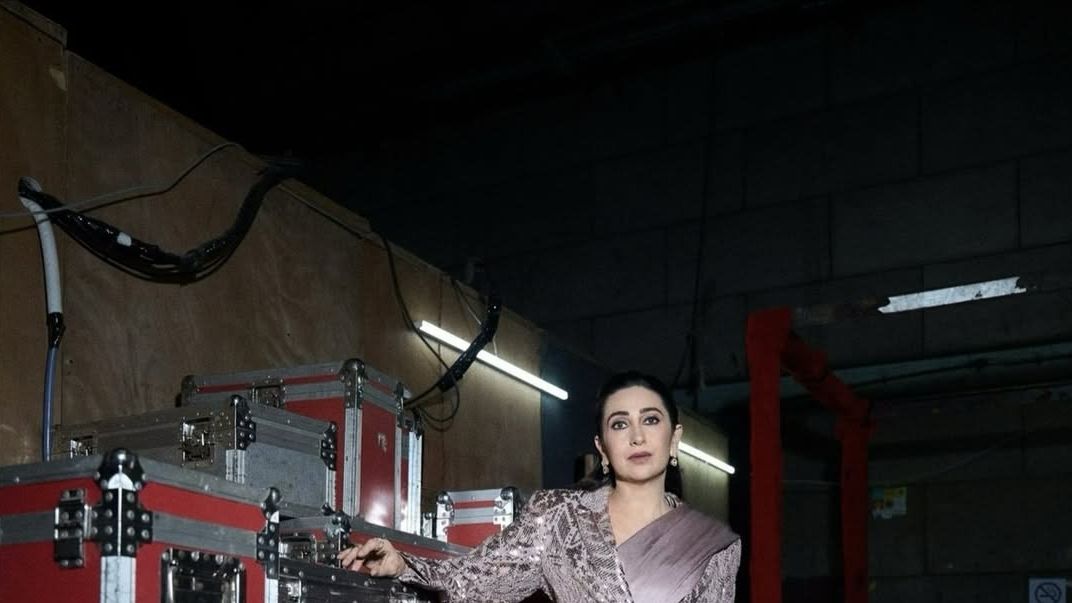 Karisma Kapoor paired a mauve Manish Malhotra sari with a sequinned tailored blazer and playful fringe pallu