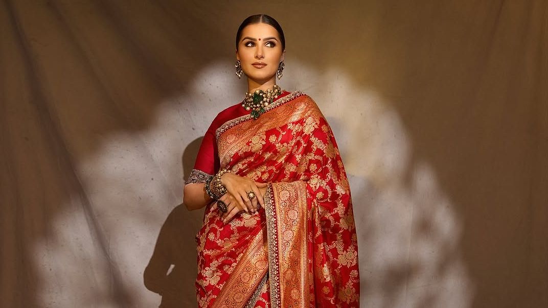 Tara Sutaria’s crimson Banarasi sari came edged with an antique gold embroidered border