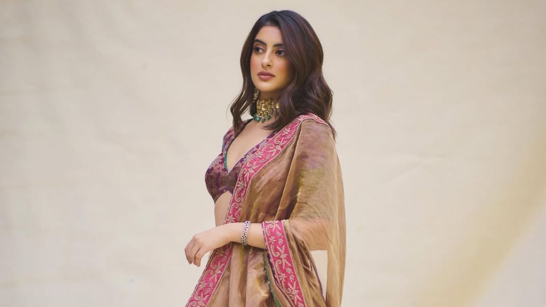 Navya Nanda’s gold tissue lehenga is paired with a vibrant vintage blouse with heritage crafts